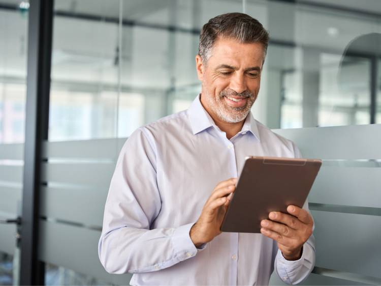 Man smiling at ipad