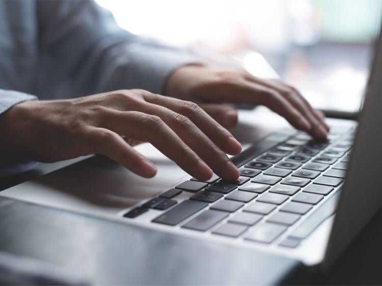 Hands typing on keyboard